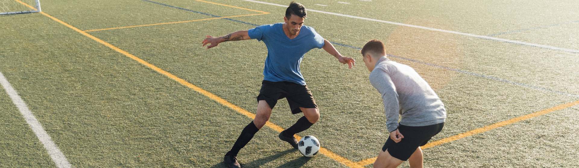 Two men playing soccer