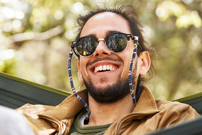 Man smiling in a hammock